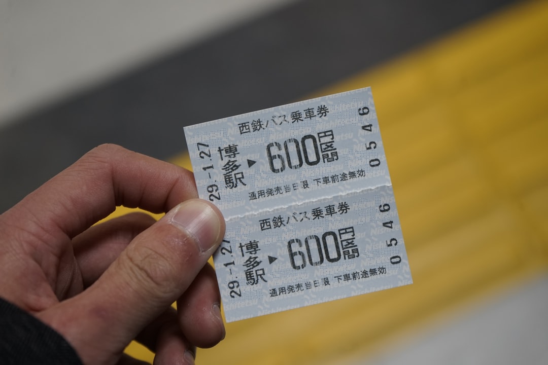 Traveler holding a rail ticket while planning train and IC card use in Japan