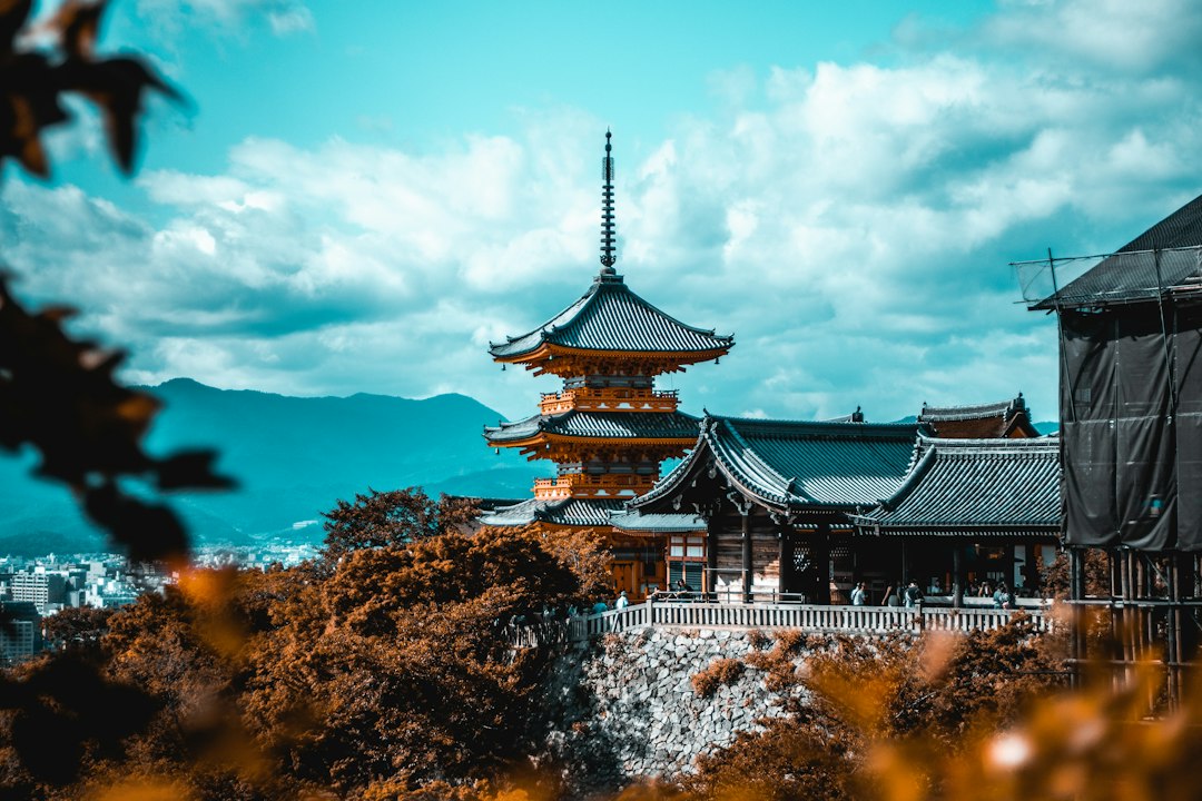 Pagoda and travelers in Kyoto during autumn