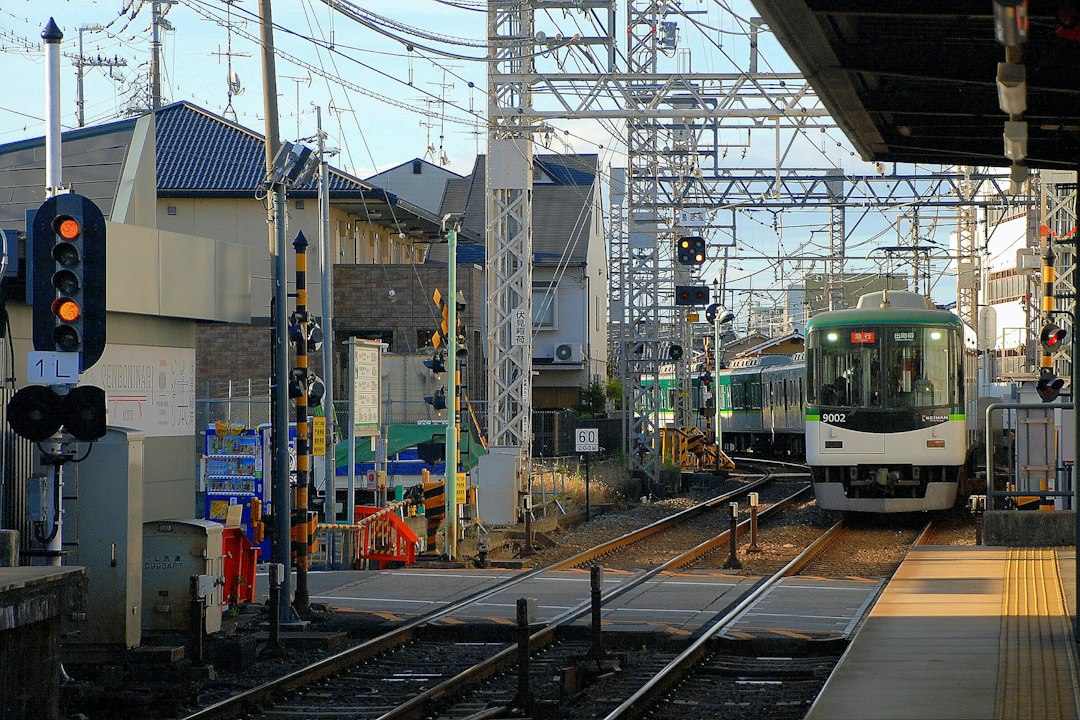 White commuter train at a Japanese railway platform