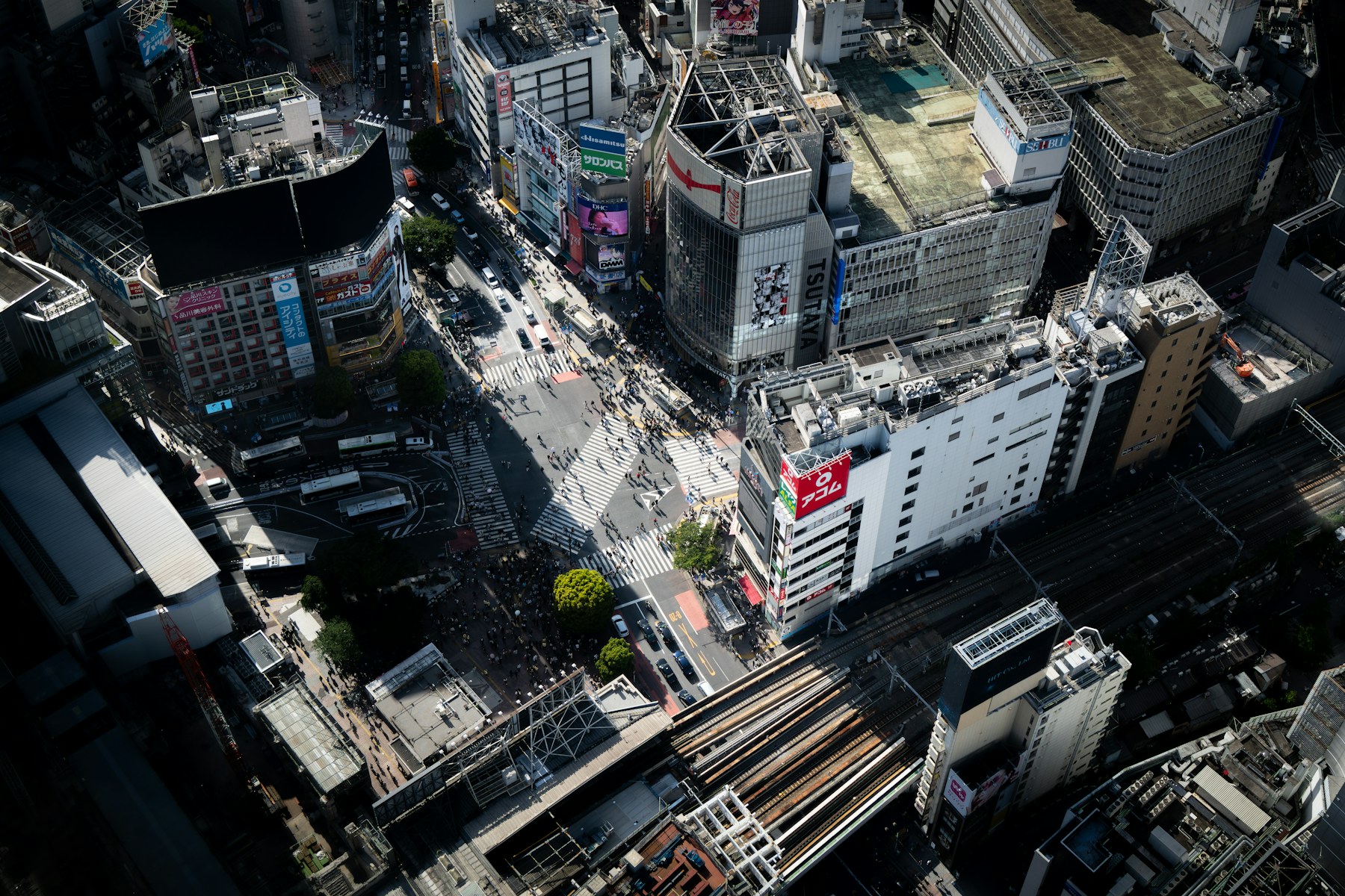 Aerial view of Shibuya Crossing and surrounding Tokyo buildings.