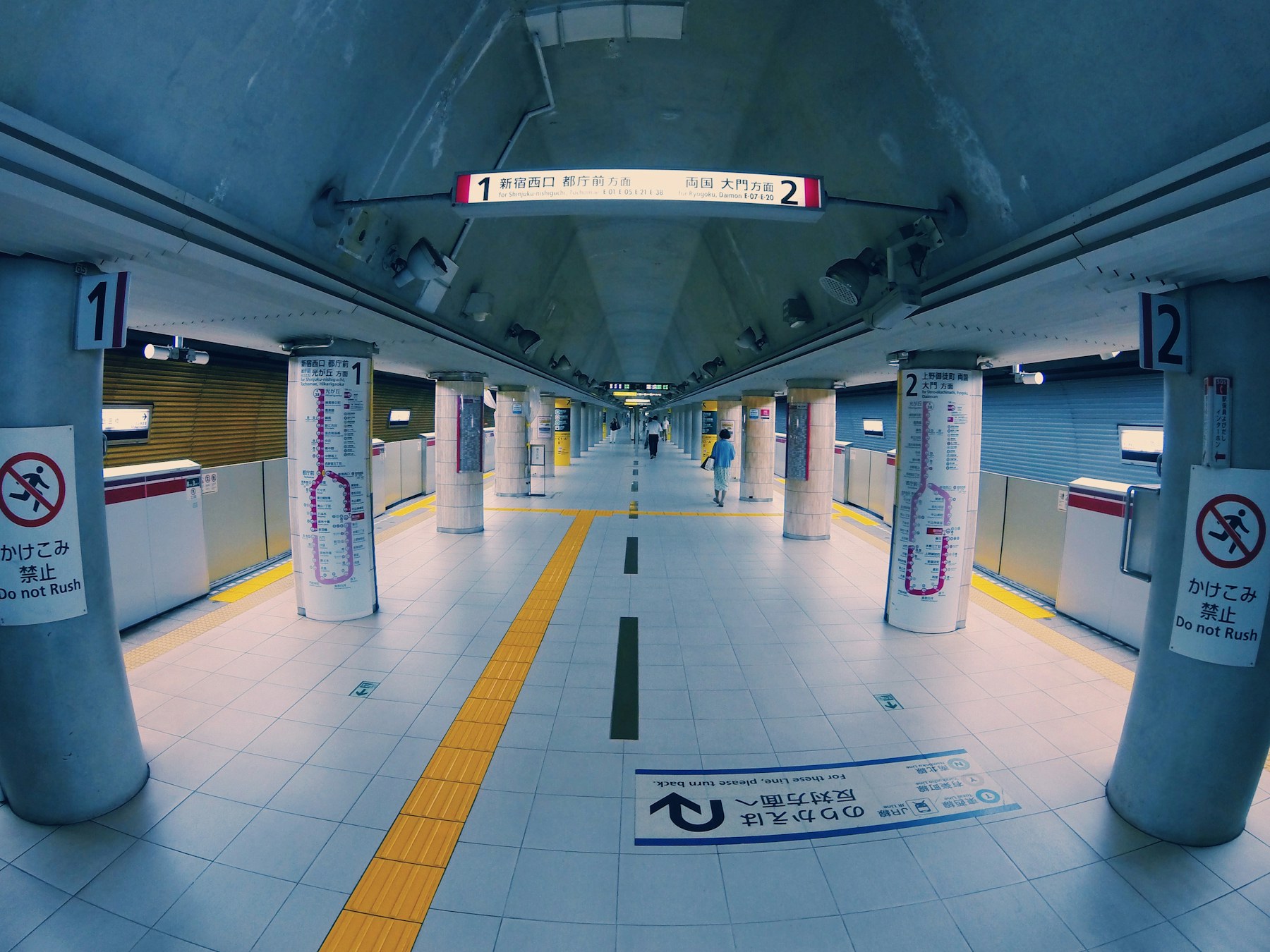 Clean, bright Tokyo subway station interior with platforms and signs